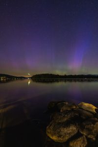 Aurora sky and fireball over the lake